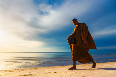 Prachuap Khiri Khan,Thailand - June, 03, 2018 : Unidentified name buddhist monk was walking alms offering food in the morning on the beach at Hua Hin Beach Prachuab Khirikhan, Thailand.のeditorial素材