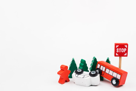 Wooded toy car are crashed. Accident road traffic with wooden toy cars in the town on white...