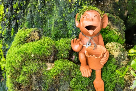Monkey statue in a flower garden.Thailandの写真素材