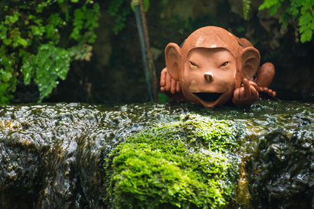 Monkey statue in a flower garden.Thailand
