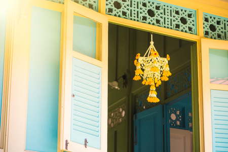 Fabric flowers hanging at white windows antique and retro curtain style at Thailandの写真素材