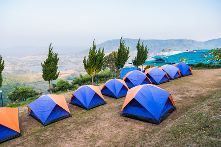 Tent on a grass under white clouds and blue sky.Thailandの写真素材