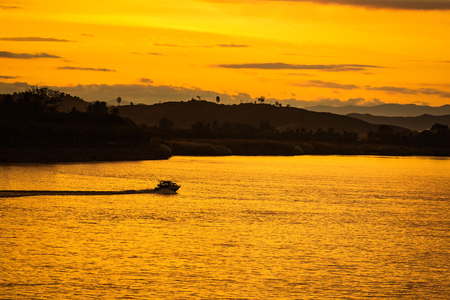 The ship is sailing in the Mekong River in In the morning, the sunrise in the Golden Triangle, Chiang Rai, Thailandの写真素材