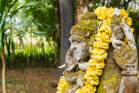 Ganesha coverd by moss in the park.Thailandの写真素材