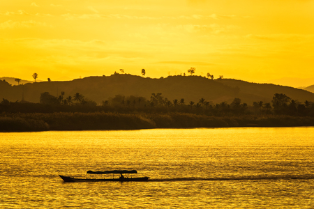 The ship is sailing in the Mekong River in In the morning, the sunrise in the Golden Triangle, Chiang Rai, Thailandの写真素材