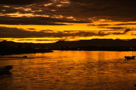 In the morning, the sun rises on the banks of the Mekong River in the Golden Triangle, Chiang Rai, Thailand.の写真素材