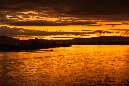 In the morning, the sun rises on the banks of the Mekong River in the Golden Triangle, Chiang Rai, Thailand.の写真素材