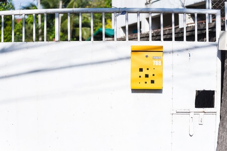 Yellow mail box on steel doors.Thailandの写真素材