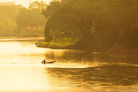 Boating in the big river in the sunrise morning time.Thailandの写真素材