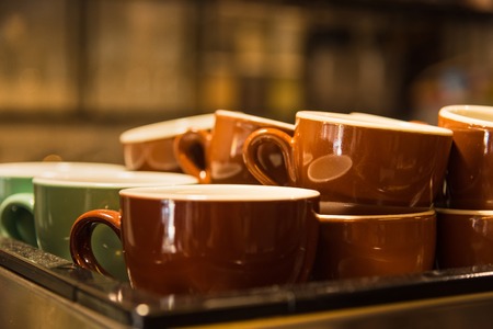 A coffee machine with a large stack of coffee cupsの写真素材