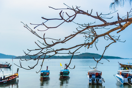 Phuket, Thailand - March, 31, 2019 : Sunrise above Tour boat on the beach. morning light shines up from the edge of the sea. A reflection on Tour boat parked on Rawai beach.Phuket, Thailandのeditorial素材