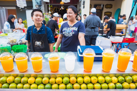 Phuket, Thailand - March, 31, 2019 : Unidentified name trader is orange Juice at weekend walking street market at Phuket Old Town.Phuket, Thailandのeditorial素材