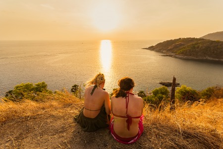 Phuket, Thailand - March, 29, 2019 : Unidentified name tourist sitting watching the sunset on top of hill with beautiful Promthep Cape, famous tourist destination in South of Thailand.Phuket islands.のeditorial素材