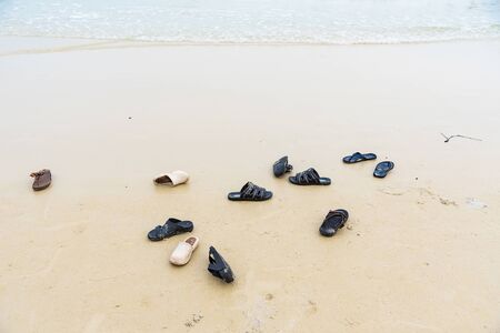 Rayong, Thailand - May, 11, 2019 : Many people take of flip flop shoes and running to the beach for funny swimming in the sea at Vongdeuan beach sunset in the Koh Samet island, Rayong, Thailandのeditorial素材