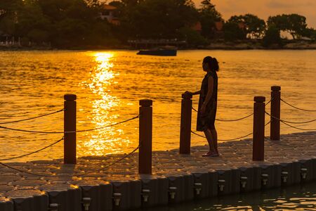 Rayong, Thailand - May, 12, 2019 : Unidentified name People on Boat jetty island stretches out into the sea at Vongdeuan beach in morning sunrise the Koh Samet island, Rayong, Thailandのeditorial素材