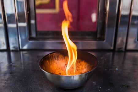 Candle flame on the lantern in Chinese temple.Thailandの写真素材