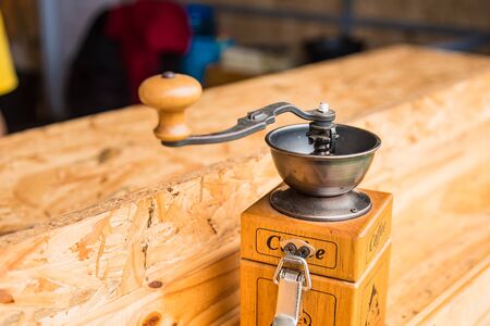 Coffee grinder on wooden table