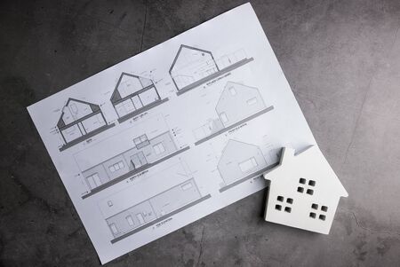 Wooden house and House plan on stone pattern background with copy space.Home Repair concept, Repair...