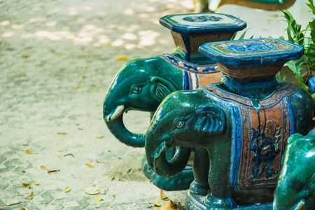 Green ceramic elephant in the gardenの写真素材