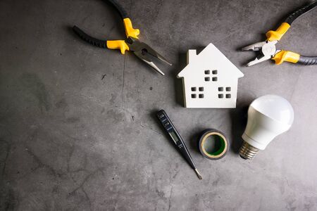Wooden house and construction tools on stone pattern background with copy space.Home Repair concept, Repair maintenance concept, Renovation conceptの写真素材