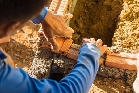 Construction worker, Bricklayer, constructing brick wallの写真素材
