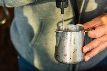 Thai Barista making a espresso with a coffee machine
