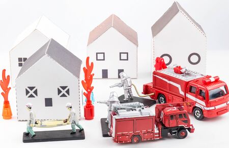 Toys staff are fighting fire, house fires and rescue house models isolated on a white background.の写真素材