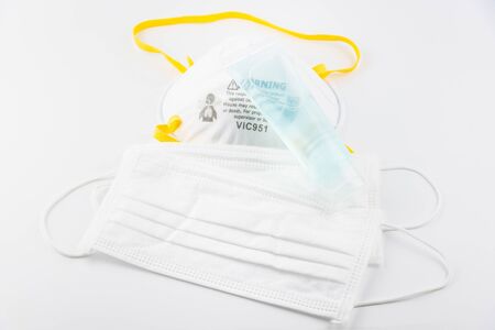 Surgical Face Mask and Alcohol gel to wash hands. Coronavirus Concept. Medical Face Mask For Stopping The Spread of Virus. Surgical mask with rubber ear straps. surgical mask to cover the mouth nose.の写真素材