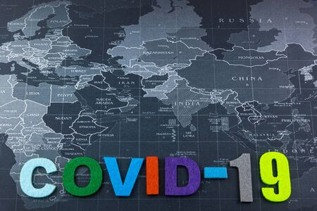 Surgical Face Mask and The letter Covid-19 on word map. Coronavirus Concept. Medical Face Mask For...