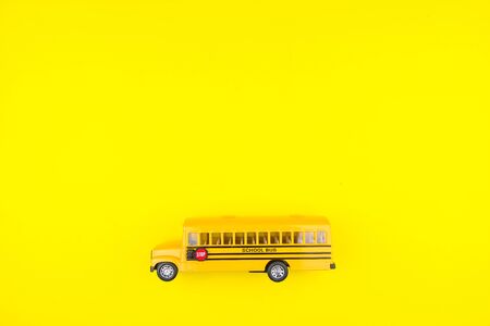 School bus toy yellow on a yellow background.の写真素材