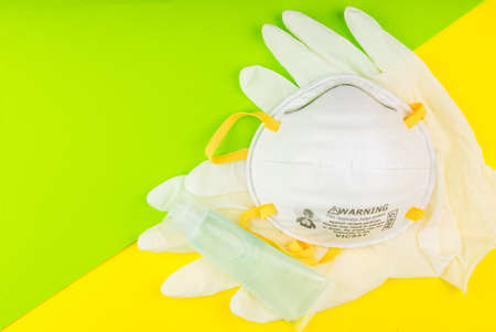 Surgical Face Mask, Rubber gloves and Alcohol gel to wash hands. Coronavirus Concept. Medical Face...