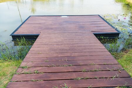 Wooden pier on the lake in nature park