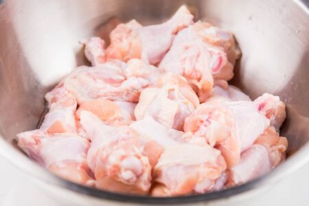 Raw Chicken wings (wingstick) in Stainless steel bowlの写真素材