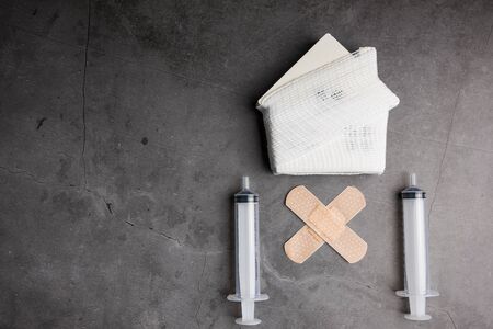 Wooden model white houses and first aid equipment on a cement gray background. Concept home repair, Home improvement, Renovate home.の写真素材