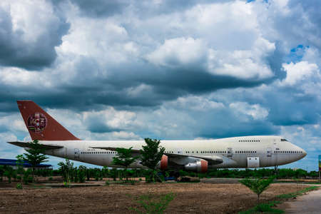 Nakhon Pathom, Thailand - June, 09, 2020 : The old commercial aircraft was discharged with a stormy sky at Nakhon Pathom, Thailandのeditorial素材