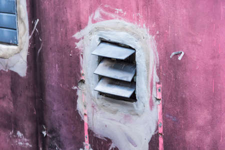 Side walk with zinc vent air on the cement wall, To reduce the heat and smell in the building, Warehouse concrete wall with air vent outlet.の写真素材