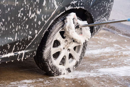 Bangkok, Thailand - April, 19, 2020 : Car washing with soap and brush. Wheel aloy cleaning at Bangkok, Thailandのeditorial素材