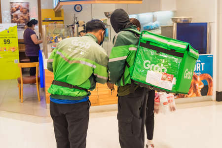 Bangkok, Thailand - April, 25, 2020 : Grab driver queues to order food. Gojek and Grab are online transportation service.のeditorial素材