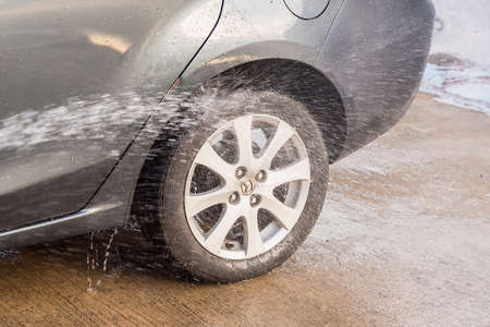 Bangkok, Thailand - April, 19, 2020 : Wash the wheels with strong water spray at Bangkok, Thailand