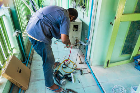 Bangkok, Thailand - June, 22, 2020 : Unidentified name worker installs air conditioner in the room at Bangkok, Thailandのeditorial素材