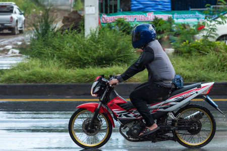Bangkok, Thailand - June, 23, 2020 : Motion Blurred panning photo of Unidentified name man riding motorcycle in the rain on road at Bangkok, Thailand.Road traffic conceptのeditorial素材