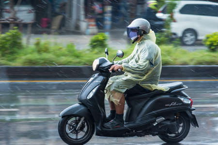 Bangkok, Thailand - June, 23, 2020 : Motion Blurred panning photo of Unidentified name man riding motorcycle in the rain on road at Bangkok, Thailand.Road traffic conceptのeditorial素材