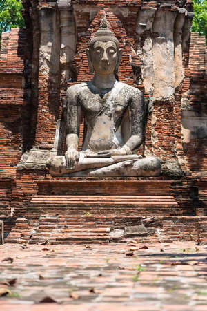 Ayutthaya, Thailand - June, 22, 2020 : Old Buddha statue sitting on brick in Wat Yai Chai Mongkhol temple, Ayutthaya, Thailandのeditorial素材