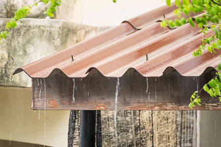 Heavy rain, raindrops run from the tiled roof. Weather forecast.Thailand.