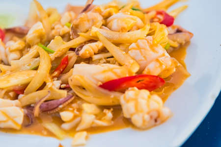 Stir-fried salted egg with squid on dish, traditional Thai foodの写真素材