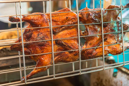 Grilled chicken on the grill,Roasted chicken on the stove,Whole roasted chicken on fireの写真素材