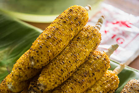 Selective focus of Grilled yellow corn for sale on street food market in Thailand , closeupの写真素材