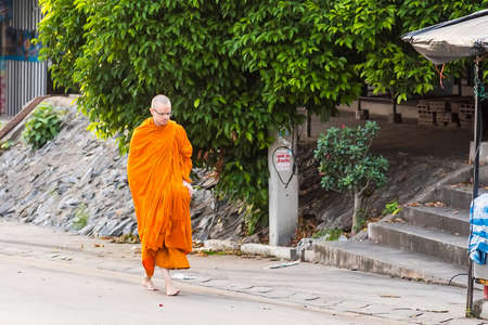 Chiangmai, Thailand - October, 10, 2020 :Unidentified name buddhist monk was walking alms offering food in the morning at Chiang Mai, Thailand.のeditorial素材