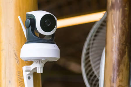 Modern CCTV security camera on building outdoors. Space for text