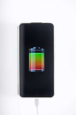 USB cable for smartphone on white background. Mobile with charger. Technology connect close up with copy space for textの写真素材